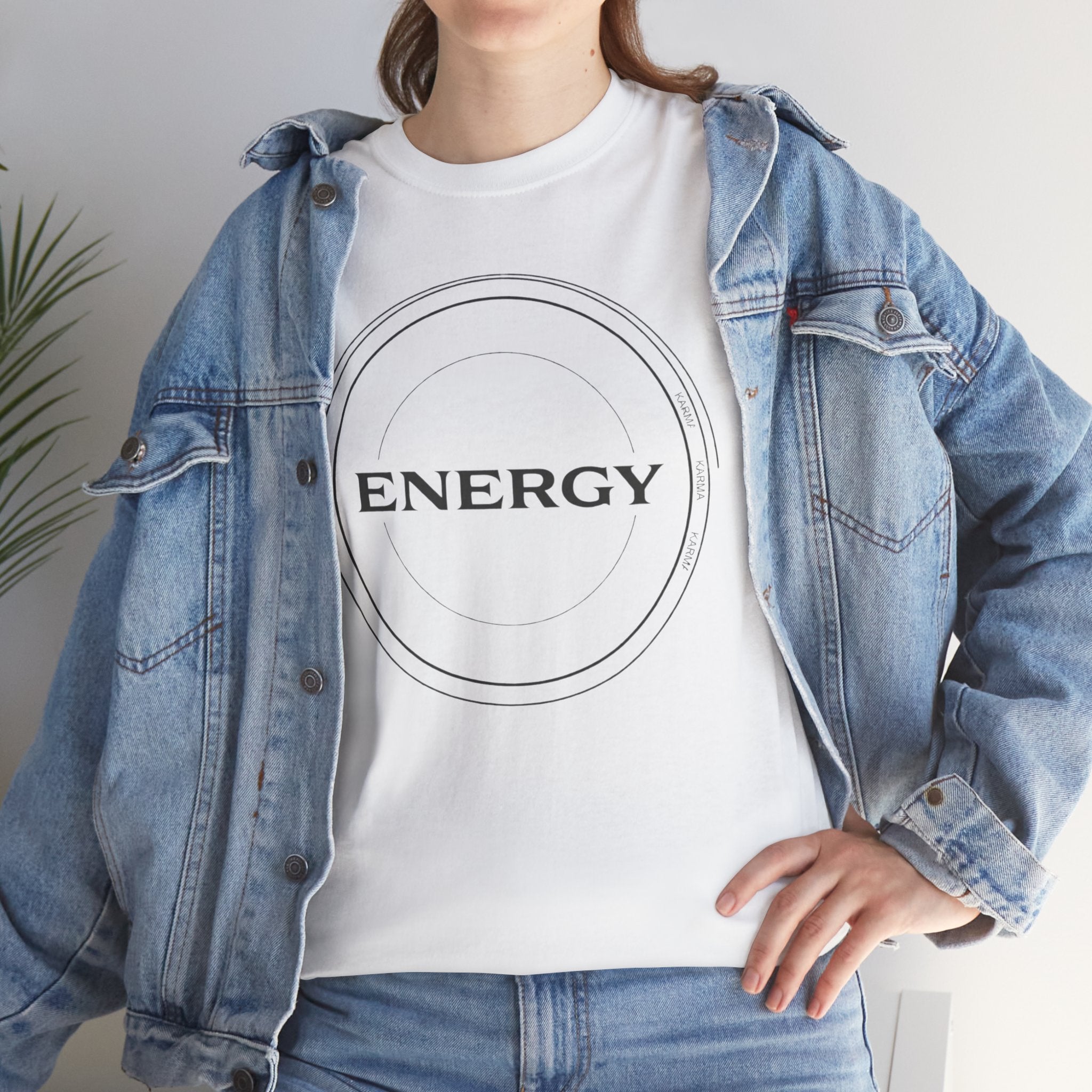 Person wearing a white t-shirt with 'ENERGY' design and a denim jacket.